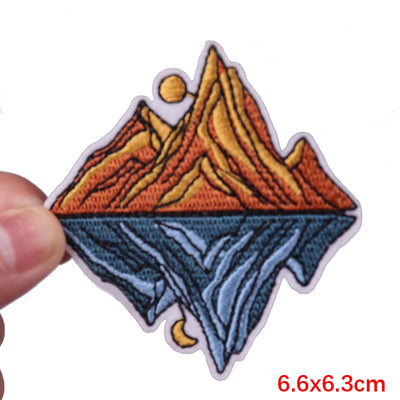 Colorful mountain design patch held by a hand with size measurement '6.6x6.3cm' displayed.