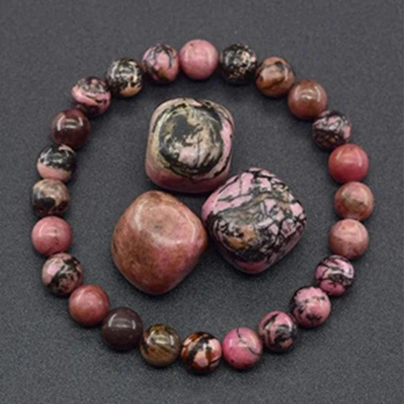 Bracelet with pink and brown marbled stones on a dark gray background