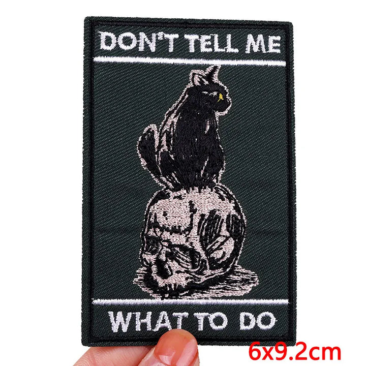 Patch with a black cat on a skull and text &