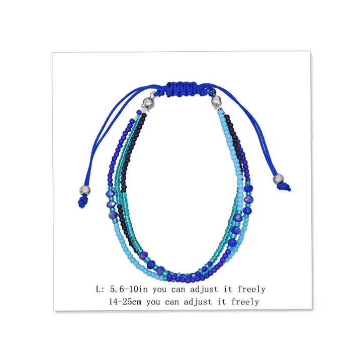 Multistrand beaded bracelet with blue and green beads on a white background