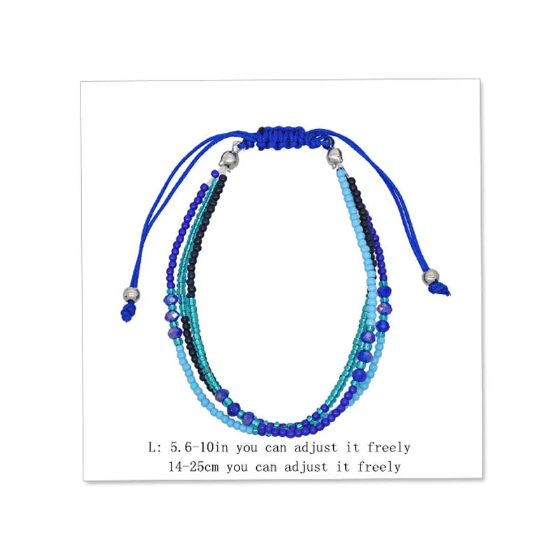 Multistrand beaded bracelet with blue and green beads on a white background