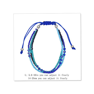 Multistrand beaded bracelet with blue and green beads on a white background