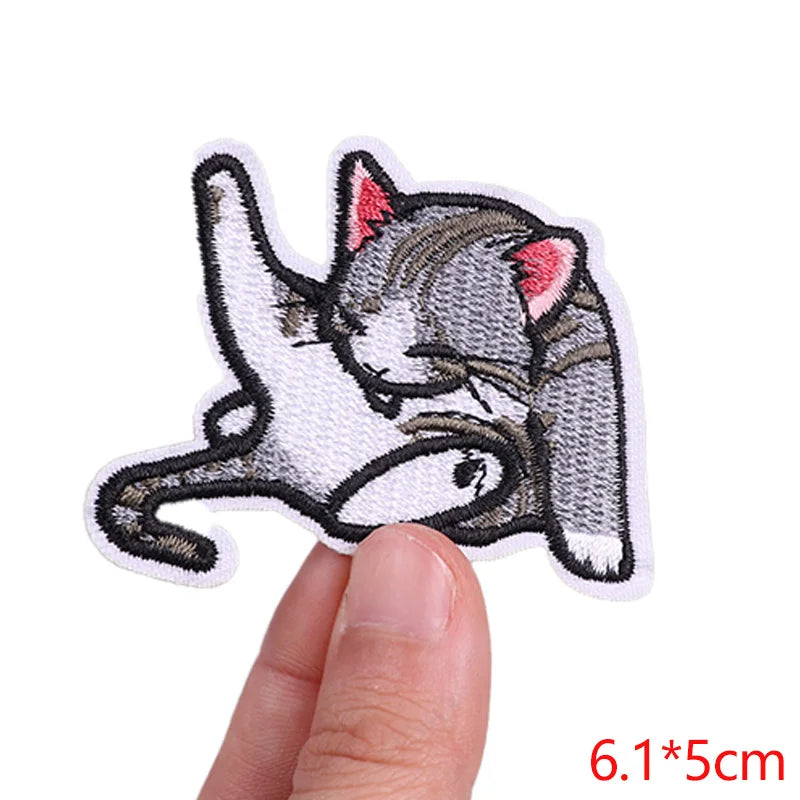 Embroidered patch of a cat on a white background
