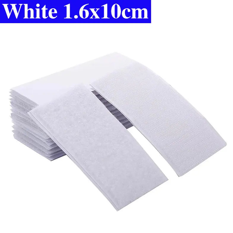 Stack of white Velcro pads with dimensions 1.6x10cm on a white background