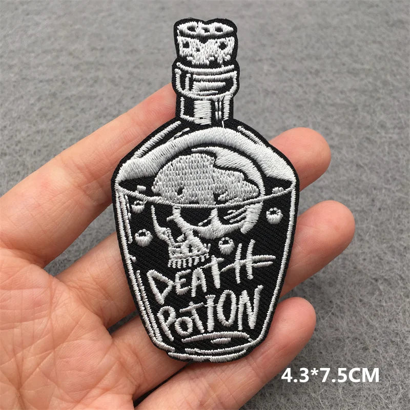 Embroidered patch of a bottle labeled 'Death Potion' held in a hand on a gray background.