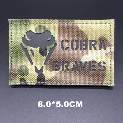 Multicam patch with 'Cobra Braves' text on a dark background