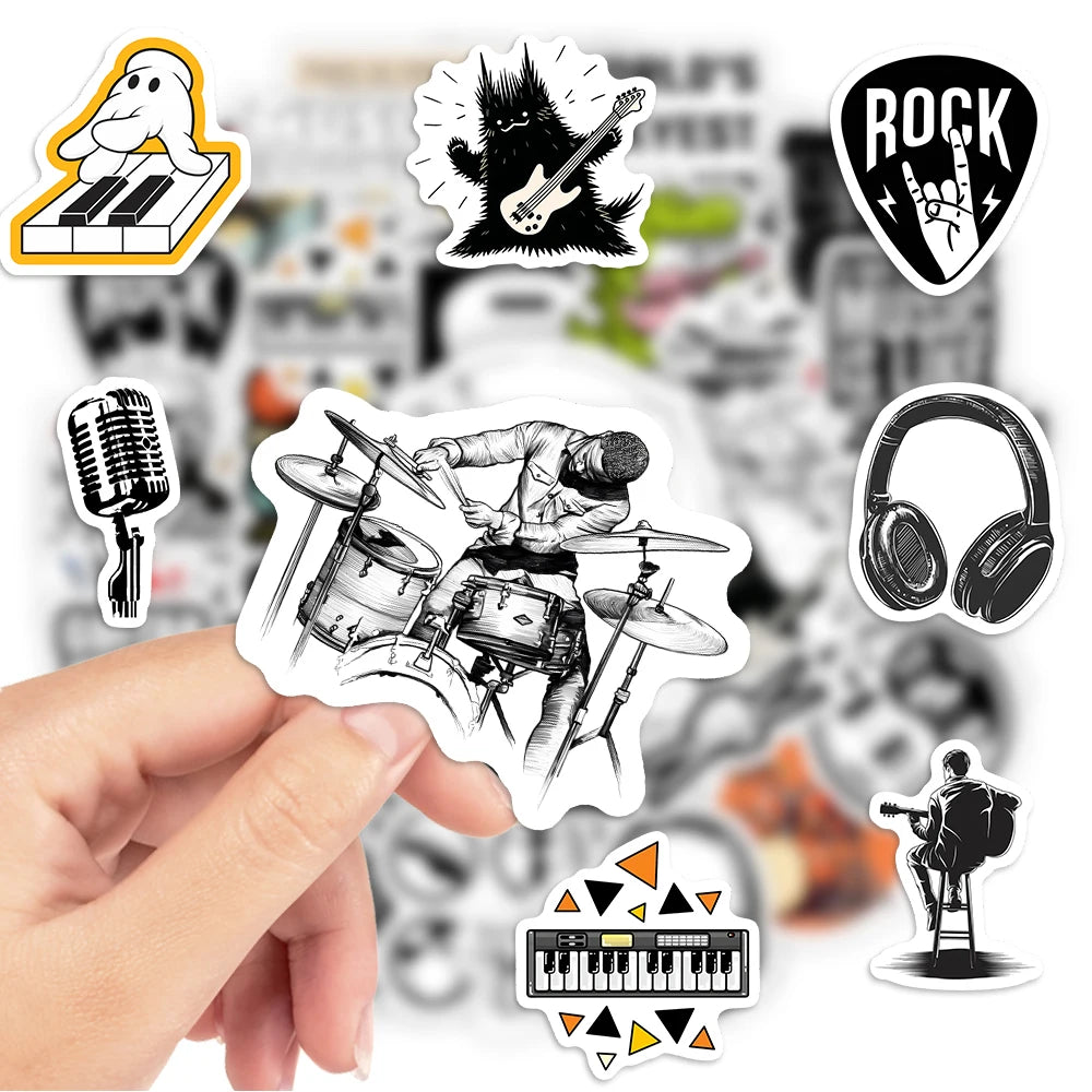 Collection of music-themed stickers featuring a drummer, guitar, microphone, headphones, and more, held by a hand with a blurred music store background.