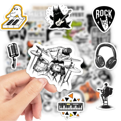 Collection of music-themed stickers featuring a drummer, guitar, microphone, headphones, and more, held by a hand with a blurred music store background.