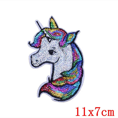 Colorful unicorn patch with sequins on a white background