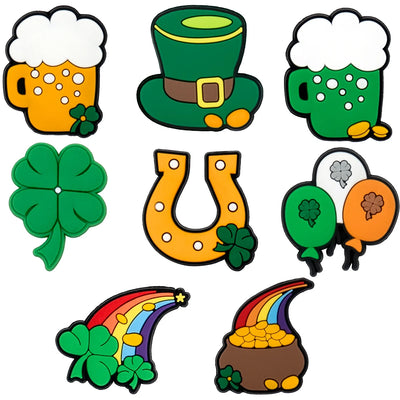 Set of St. Patrick's Day-themed shoe charms including beer mugs, leprechaun hat, four-leaf clover, horseshoe, rainbow, and pot of gold on a white background.