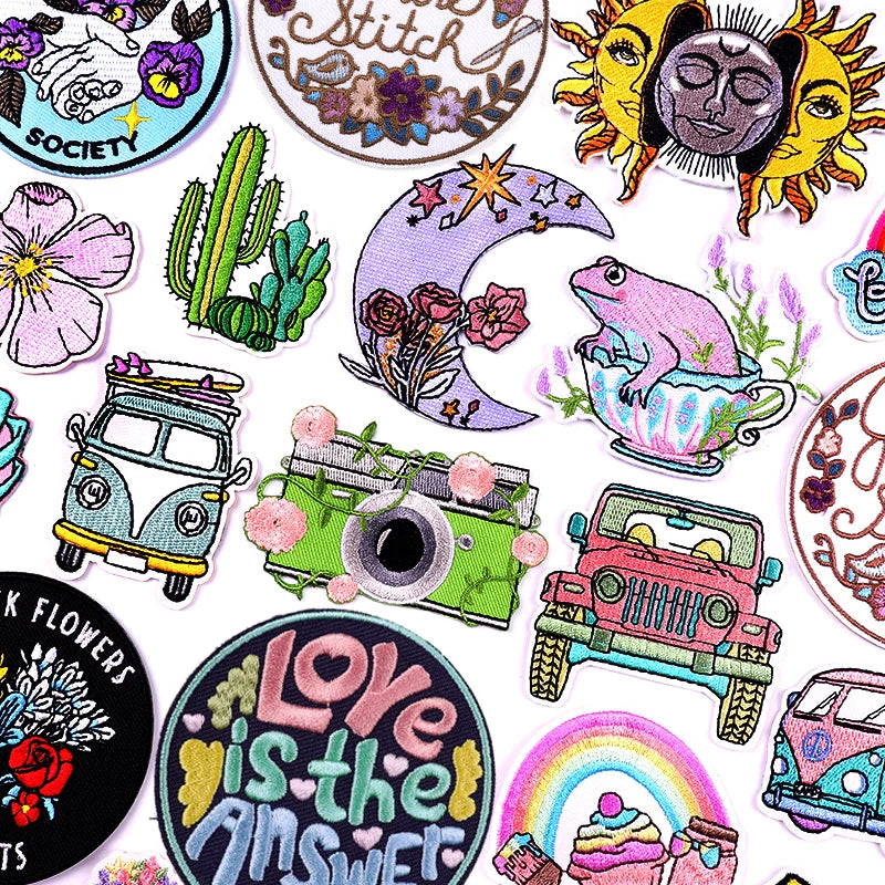 Collection of colorful embroidered patches with various designs on a white background.