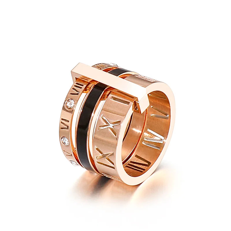 Rose gold ring with Roman numeral design on a white background