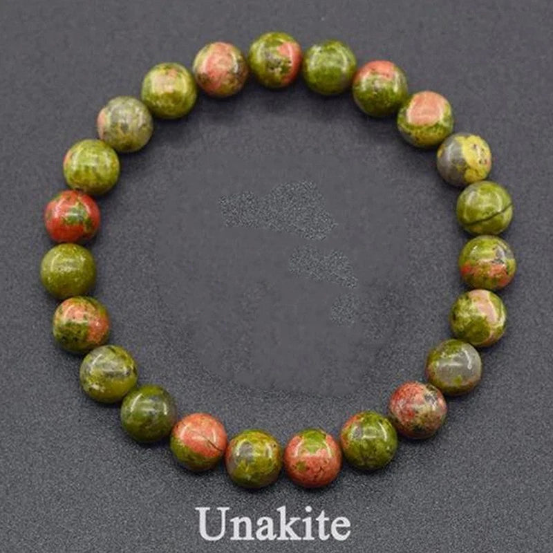 Unakite beaded bracelet on a dark gray background with &