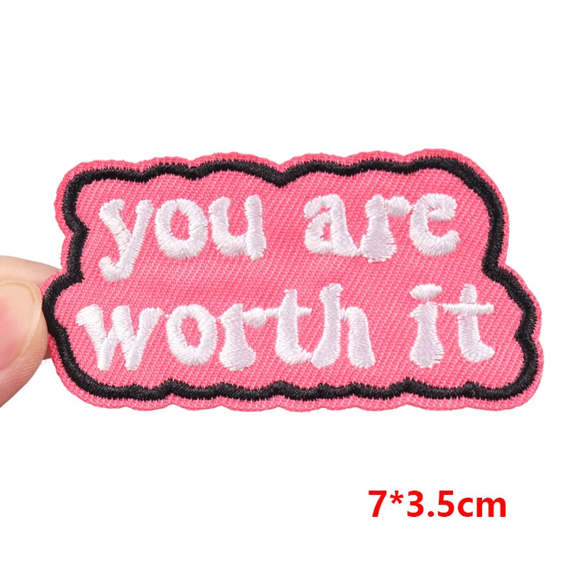 Pink patch with 'you are worth it' text held by a hand, size 7*3.5cm