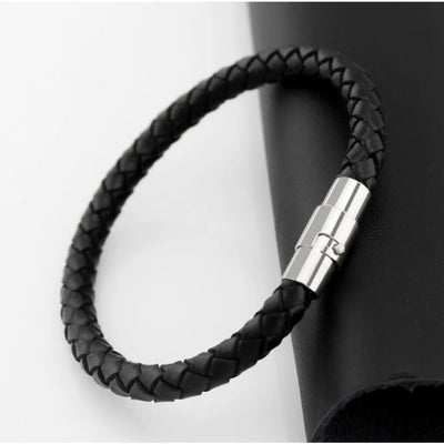 Black braided leather bracelet with a silver clasp on a white background