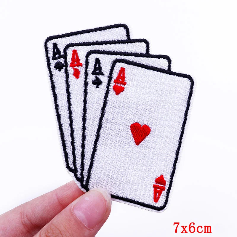 Four aces from a deck of cards held by a hand on a white background
