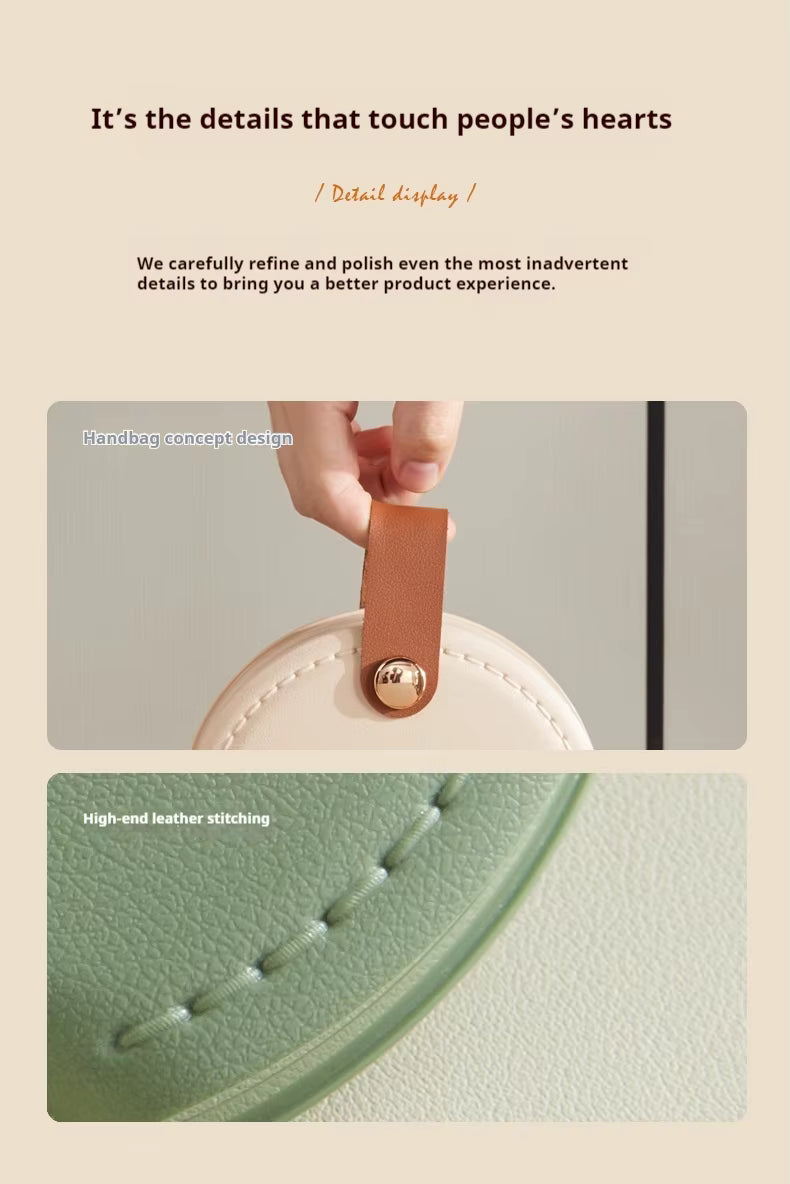 Close-up of portable sewing kit case with leather-style handle, stitching detail and snap button