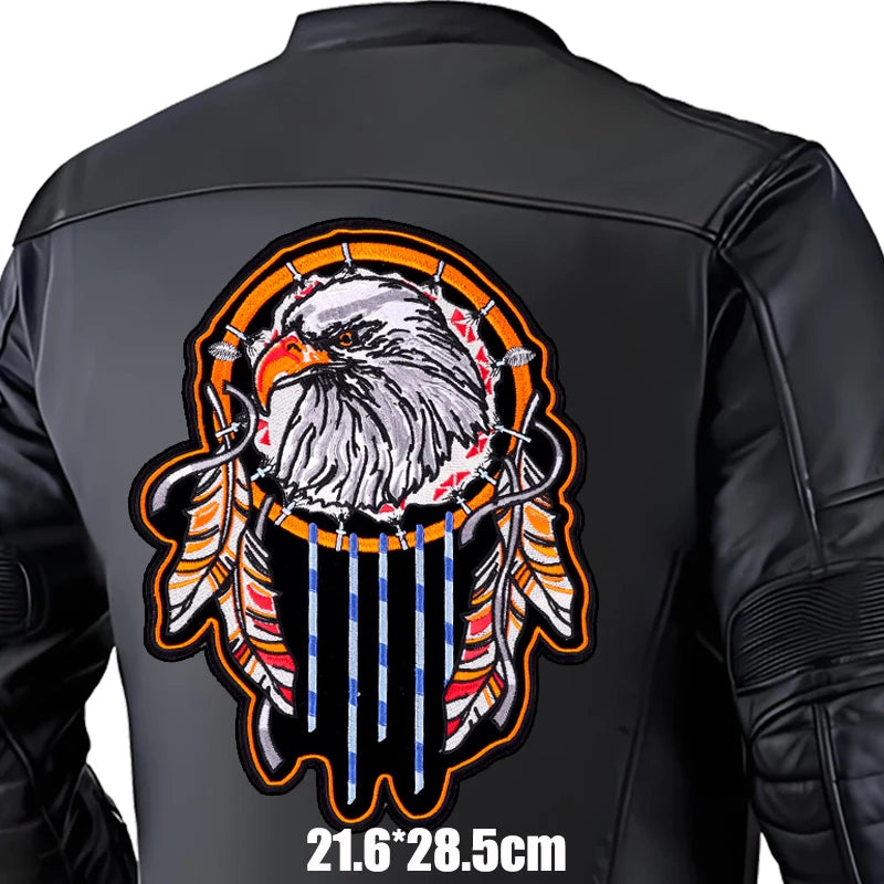 Black leather jacket with an eagle and dreamcatcher design on the back, on a white background.