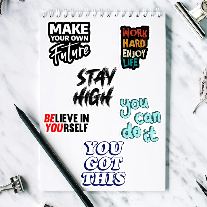 Notebook with motivational quotes on a marble surface