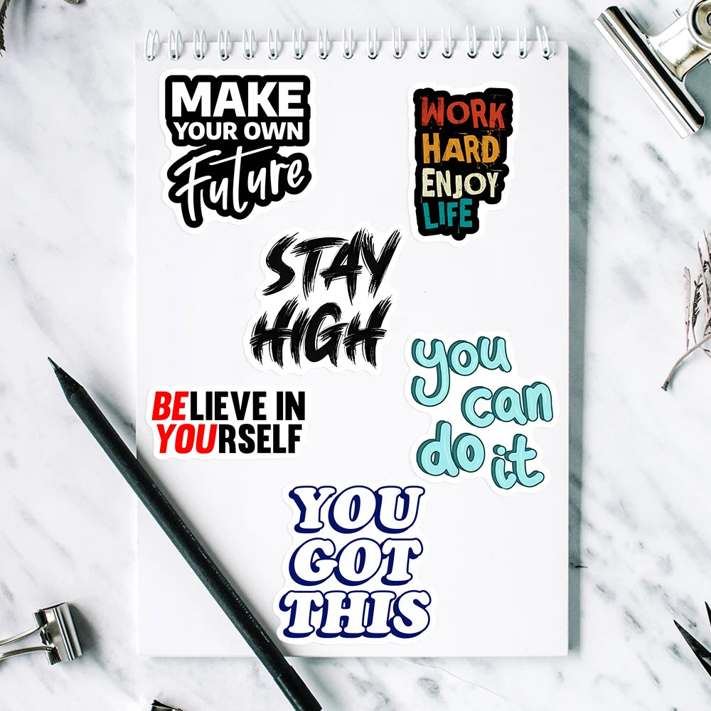 Notebook with motivational quotes on a marble surface