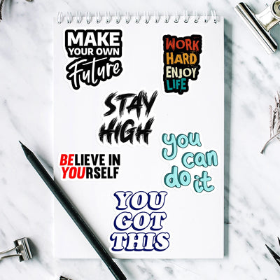 Notebook with motivational quotes on a marble surface