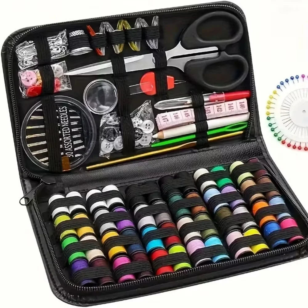 Sewing kit with spools of thread, scissors, and other tools in a black case.