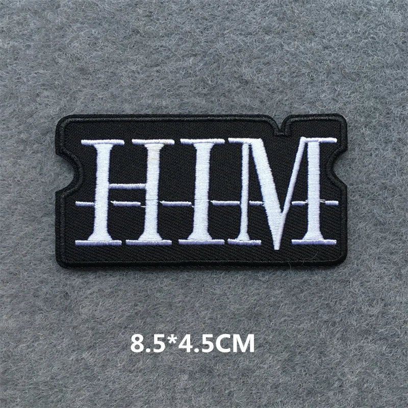 Black and white 'HIM' patch on a gray background with dimensions displayed.