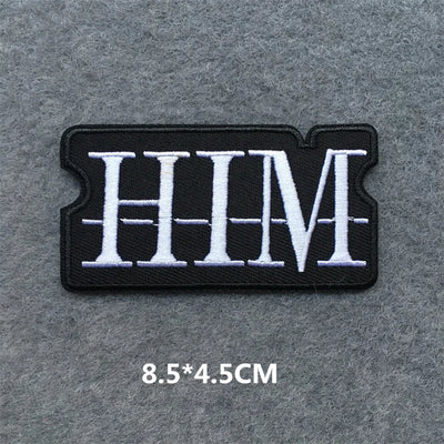 Black and white 'HIM' patch on a gray background with dimensions displayed.