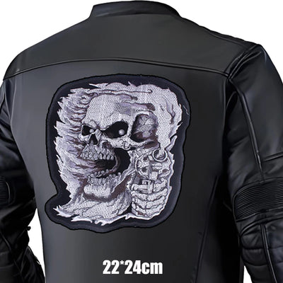 Black leather jacket with a large skull and mechanical design patch on the back, size 22x24cm.