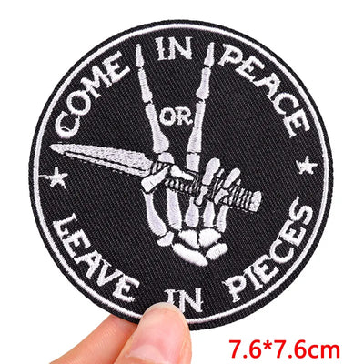 Black and white patch with skeleton hand and text held by a hand, size 7.6*7.6cm.