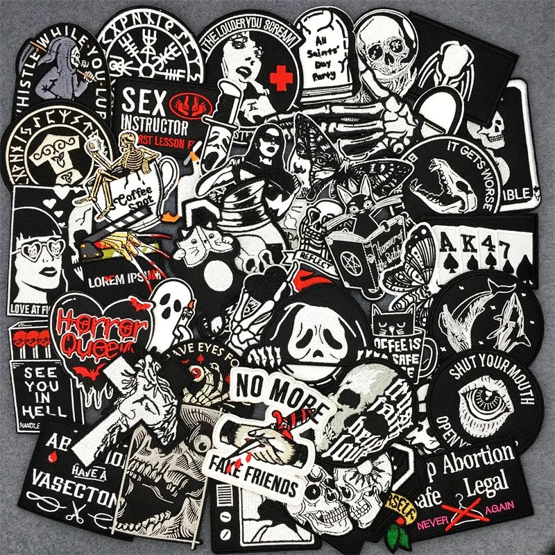 Collection of black and white stickers with various designs on a gray background