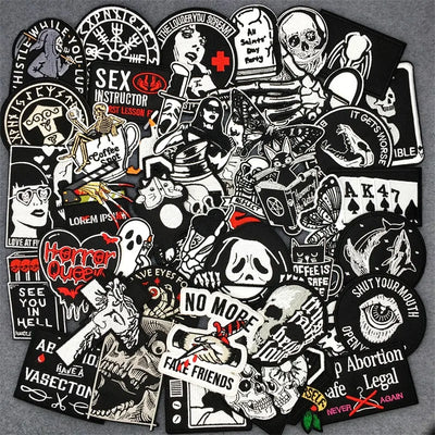 Collection of black and white stickers with various designs on a gray background