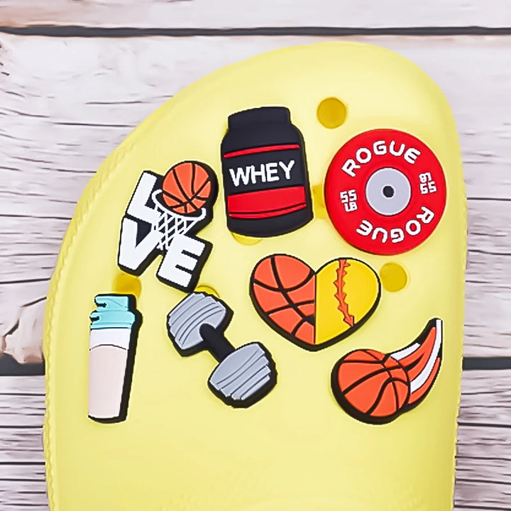 Yellow clog with sports-themed  various shoe charms on a wooden surface