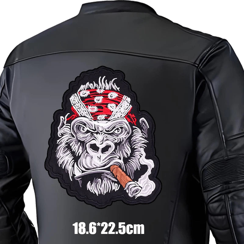 Black leather jacket with a graphic design of a monkey wearing a bandana and smoking a cigar on the back.