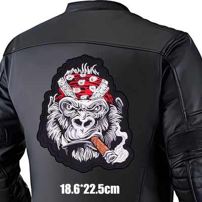 Black leather jacket with a graphic design of a monkey wearing a bandana and smoking a cigar on the back.