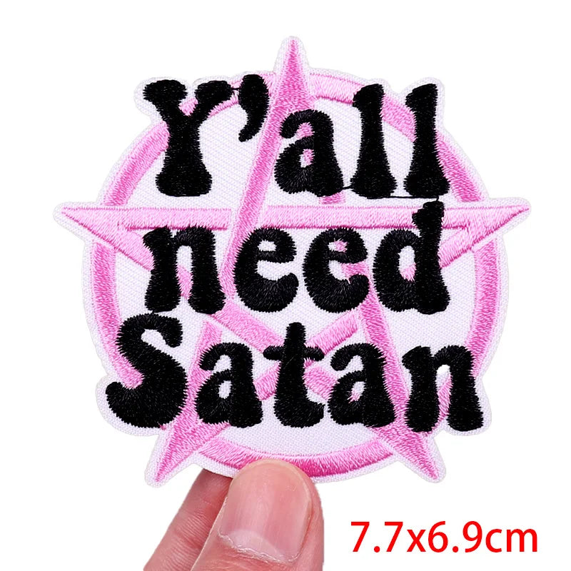 Pink pentagram patch with 'Y'all need Satan' text held by a hand, size 7.7x6.9cm.