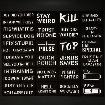Collection of black stickers with white text on a dark background