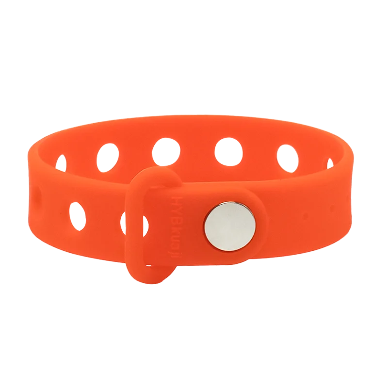 Orange wrist band with a silver button on a white background