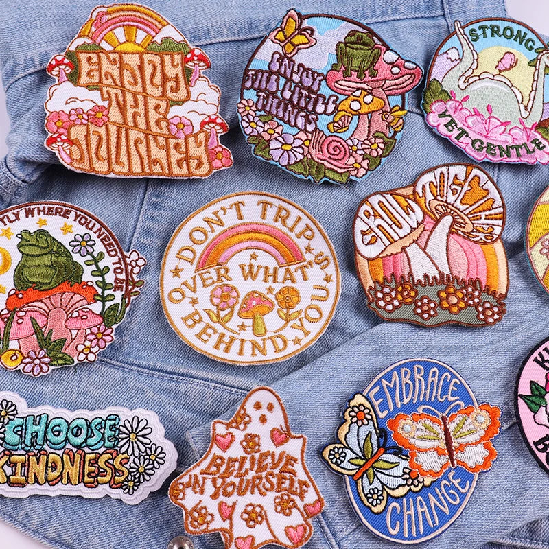 Collection of colorful embroidered patches on a denim background