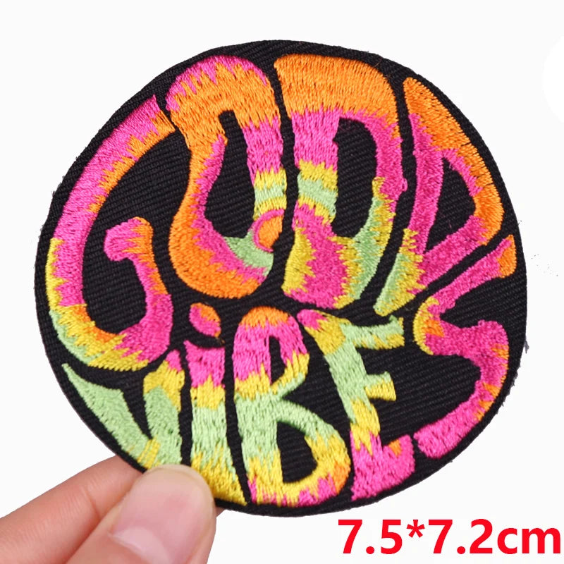 Colorful 'Good Vibes' patch held by a hand with dimensions displayed.