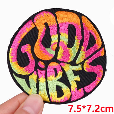 Colorful 'Good Vibes' patch held by a hand with dimensions displayed.