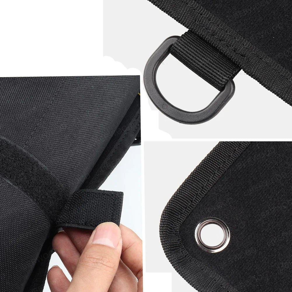 Close-up of black patch display boards straps with grommets and a hand holding one strap.