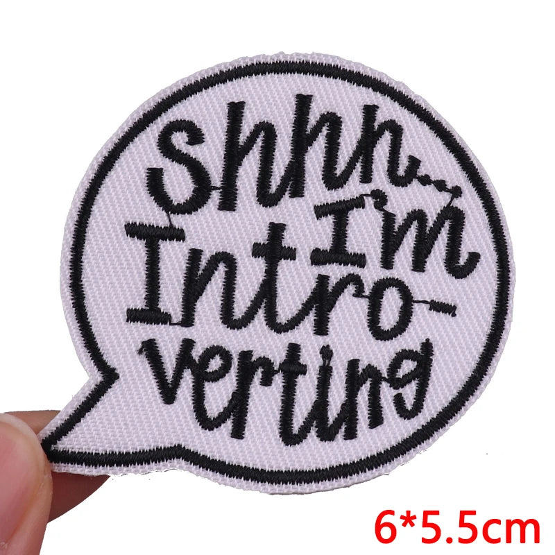 Embroidered patch with 'Shhh... I'm Introverting' text on a white background