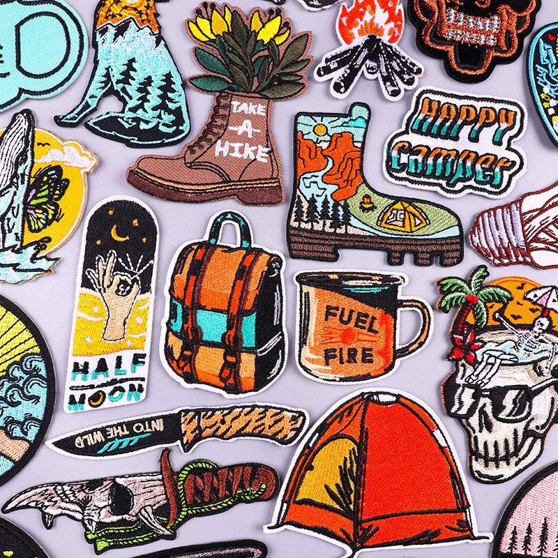 Collection of colorful camping-themed stickers on a light gray background