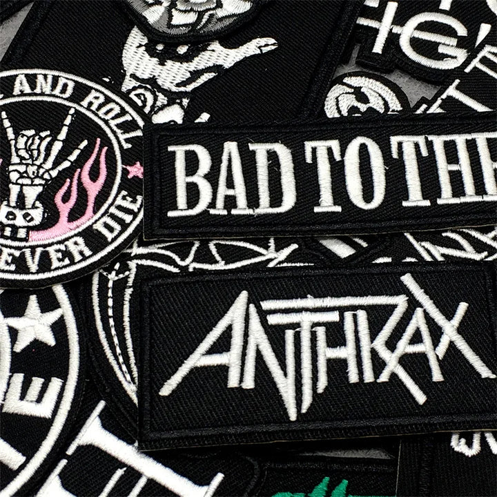 Collection of embroidered patches with text and logos, including &