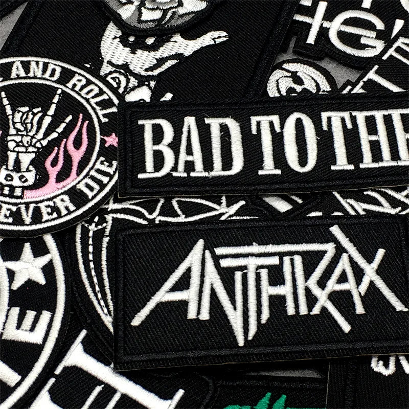 Collection of embroidered patches with text and logos, including 'Bad to the Bone' and 'Anthrax'.