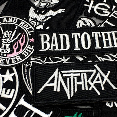 Collection of embroidered patches with text and logos, including 'Bad to the Bone' and 'Anthrax'.