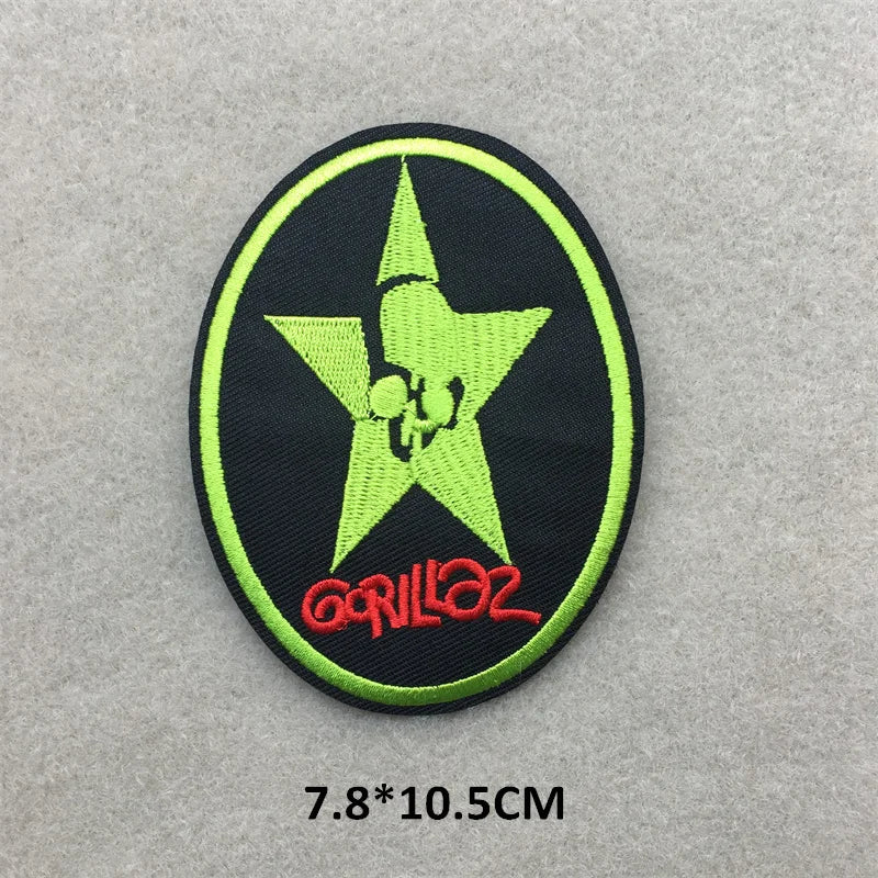 Embroidered patch with a green star and red text on a gray background