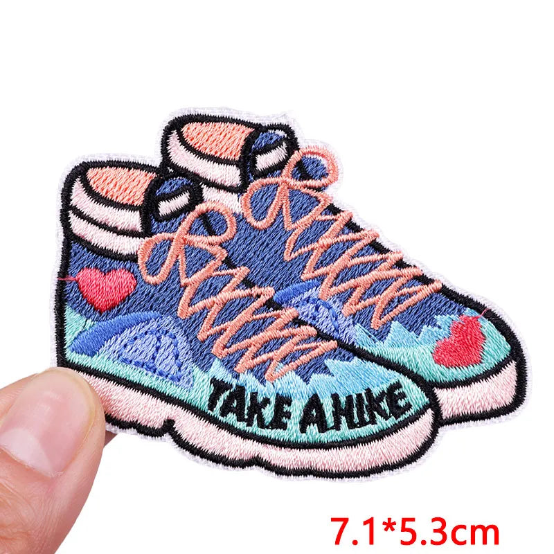 Embroidered patch of a sneaker with 'Take A Hike' text on a white background