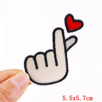 Handmade patch with a hand gesture and heart held by a hand, size 5.5x5.7cm.